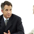 Businessman Conducting a Meeting with His Staff Businessman Conducting a Meeting with His Staff --- Image by © Royalty-Free/Corbis