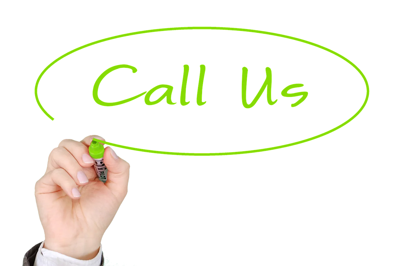 Hand holding green marker drawing oval speech bubble with "Call Us" text